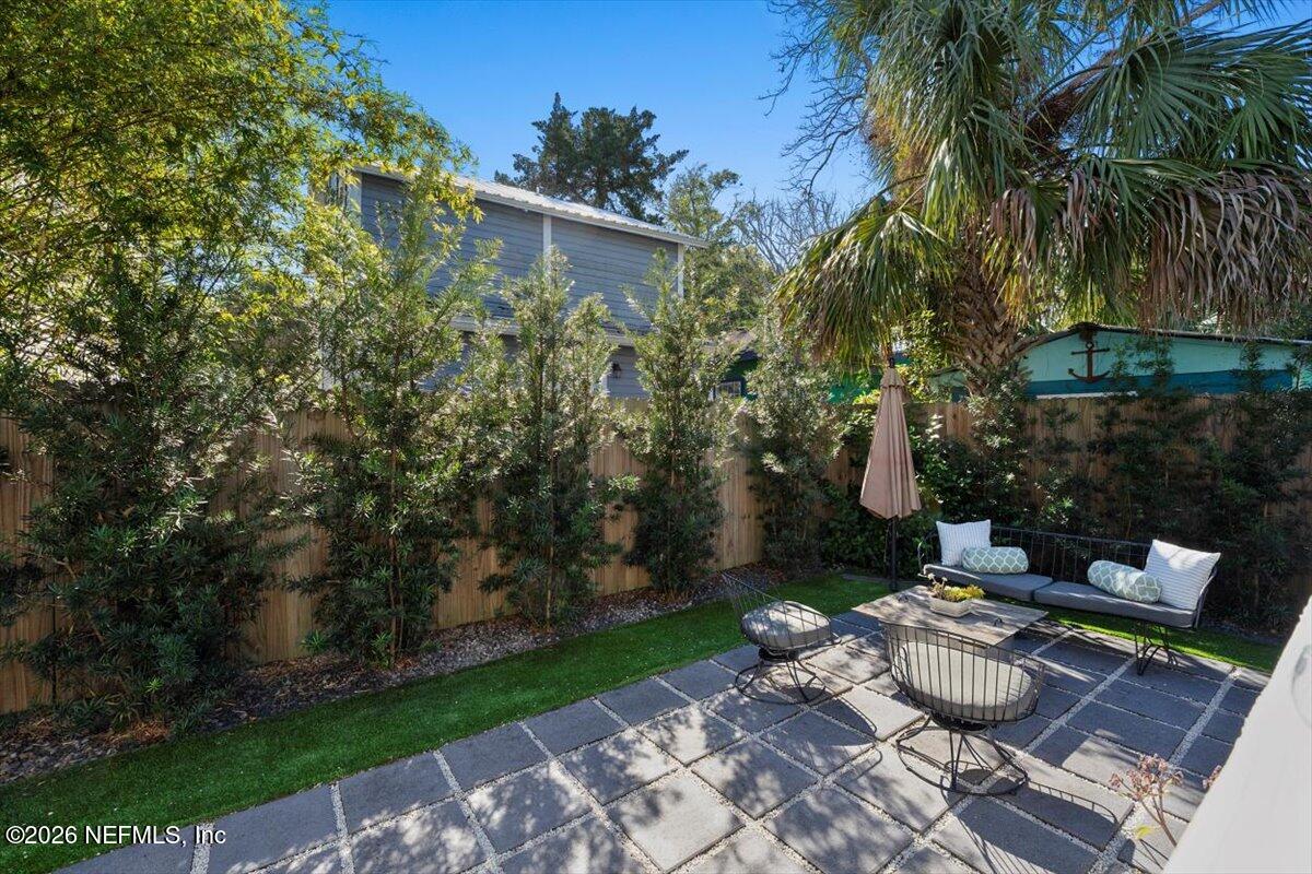 71 Kings Ferry Way St. Augustine, FL 32084 - Photo 31 of 33 a view of a patio with couches table and chairs and potted plants