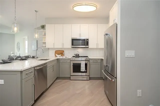 a kitchen with a sink stove and refrigerator