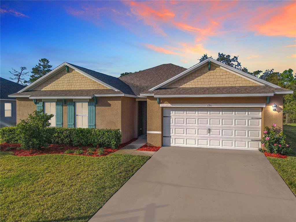 196 Rip Cord Lane DeLand, FL 32724 - Photo 1 of 1 a front view of a house with a yard and garage