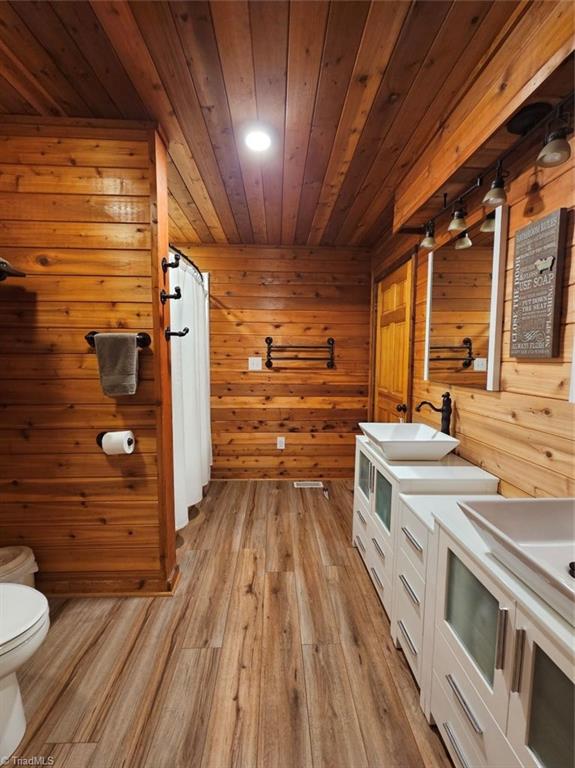6234 Davis Mill Road Randleman, NC 27317 - Photo 13 of 35 Main level primary bedroom with soft wood tones and tongue & groove white washed ceiling