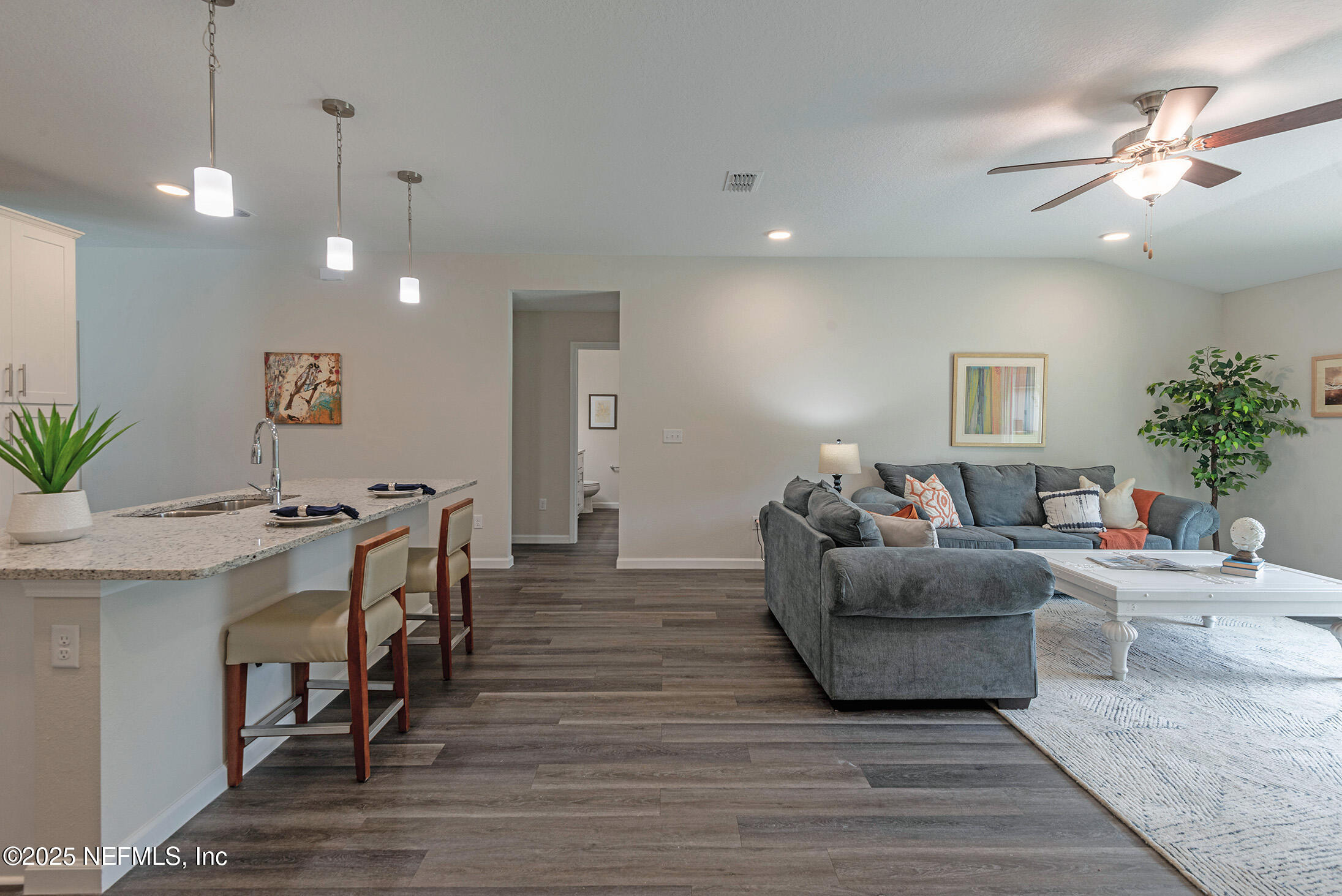 8784 Orme Road Jacksonville, FL 32220 - Photo 30 of 45 a living room with furniture and a chandelier
