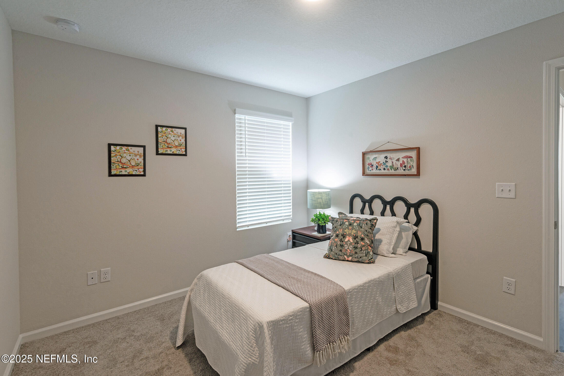 8784 Orme Road Jacksonville, FL 32220 - Photo 32 of 45 a bedroom with a bed and paintings on the wall