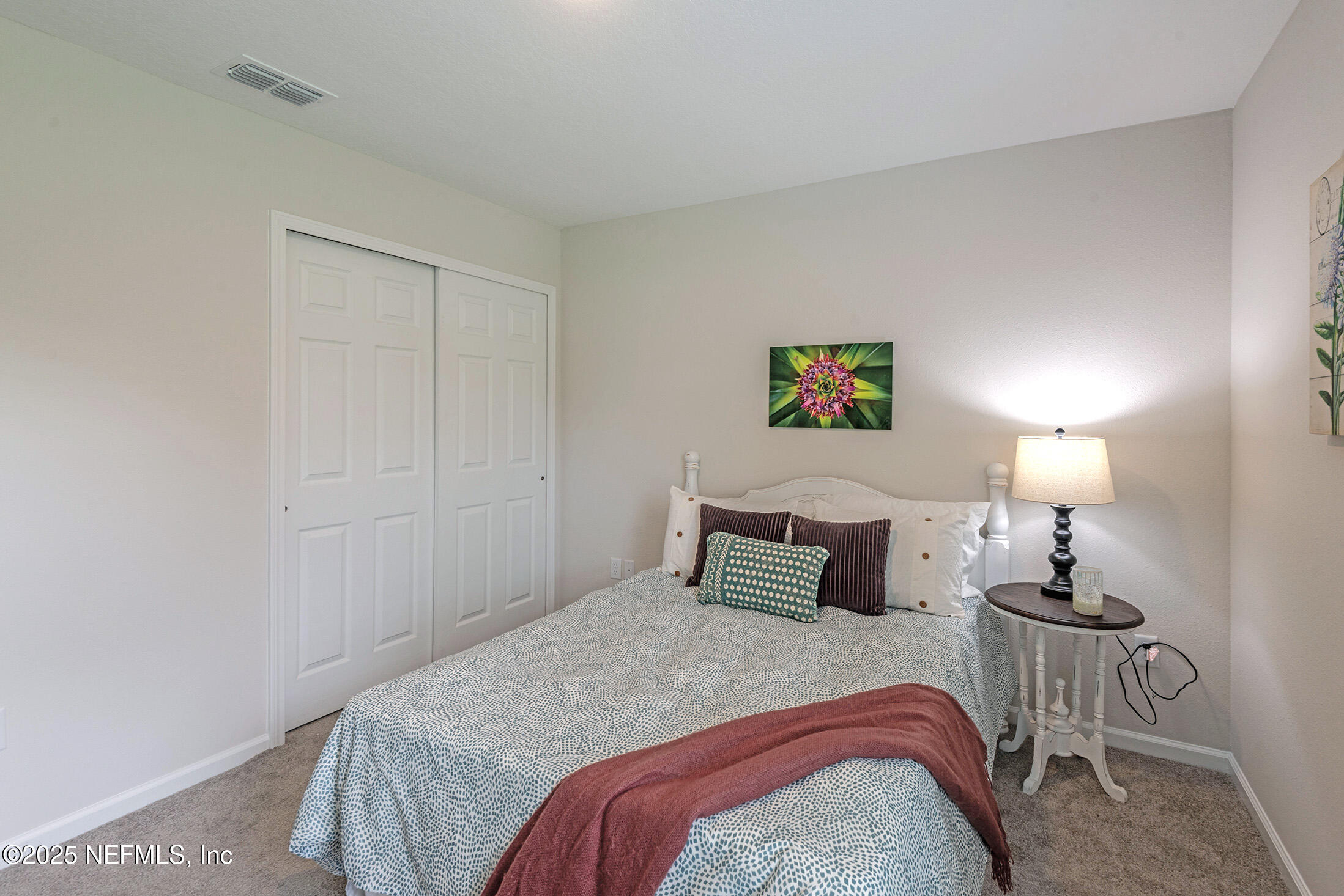 8784 Orme Road Jacksonville, FL 32220 - Photo 38 of 45 a bedroom with a bed and wooden floor