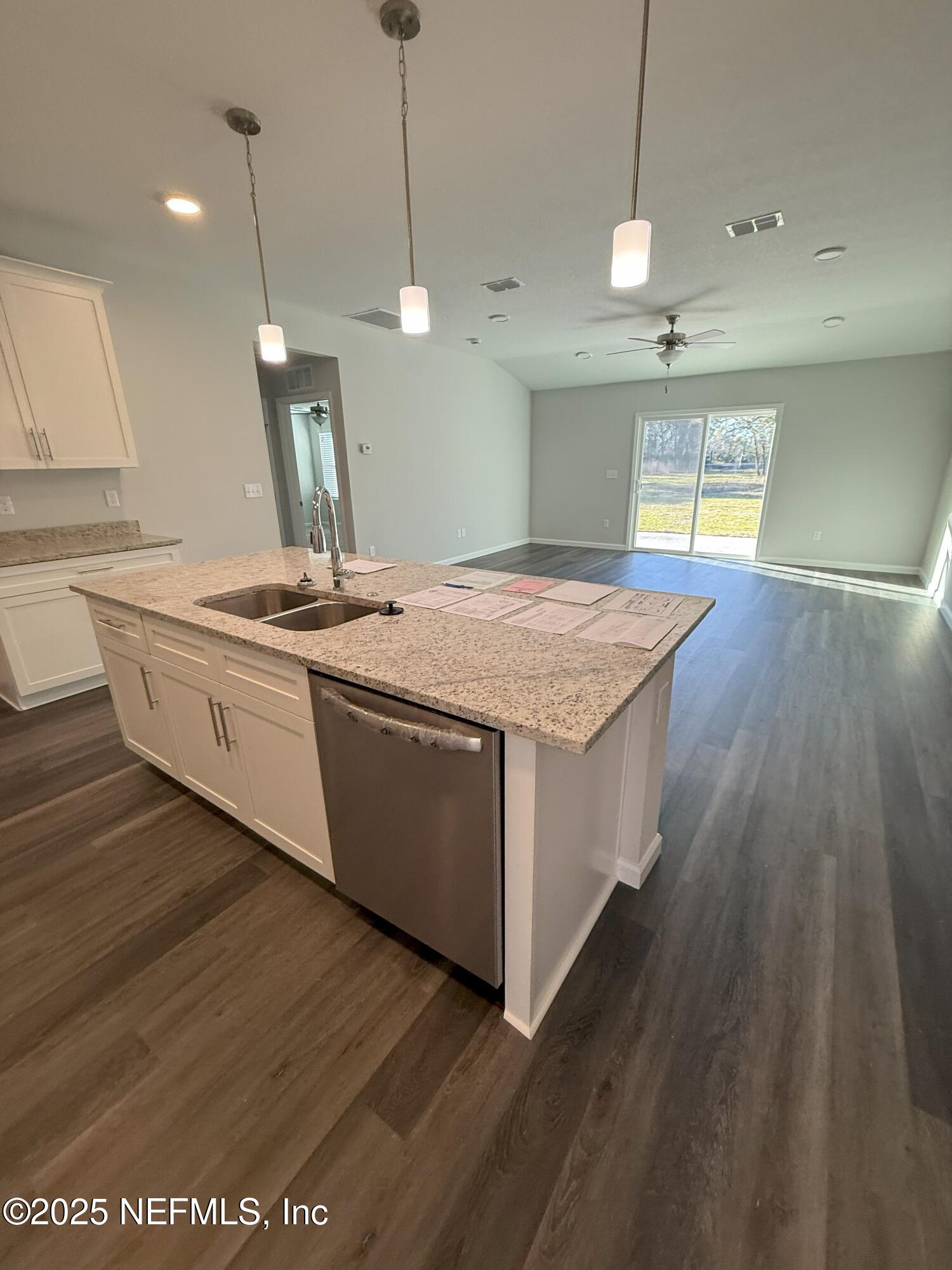 8784 Orme Road Jacksonville, FL 32220 - Photo 45 of 45 a kitchen with a stove and a wooden floor
