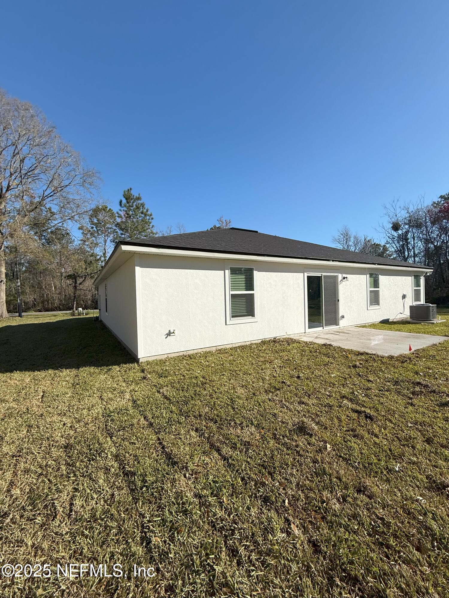 8784 Orme Road Jacksonville, FL 32220 - Photo 4 of 45 a big house with a big yard and large trees