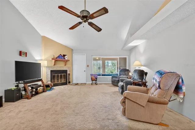 a living room with furniture a window and a flat screen tv