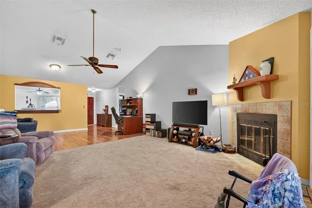 a kitchen with stainless steel appliances granite countertop a stove a sink dishwasher a dining table and chairs with wooden floor