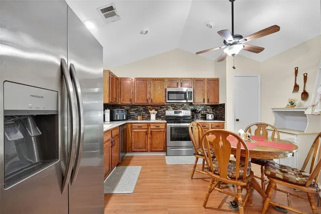 a kitchen with kitchen island granite countertop a sink a counter top space and cabinets