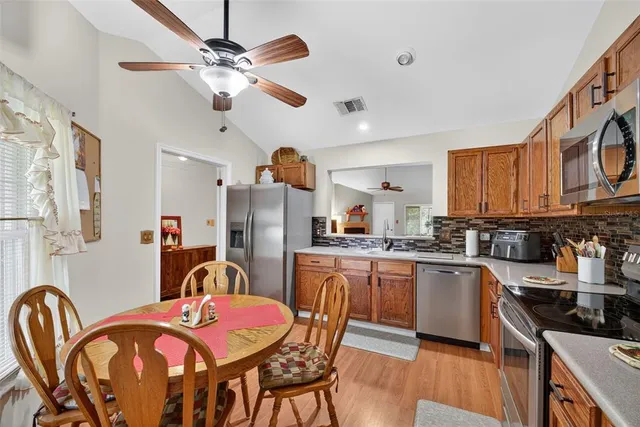 a kitchen with stainless steel appliances granite countertop a sink stove and microwave