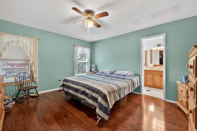 a bathroom with a granite countertop sink and a large mirror