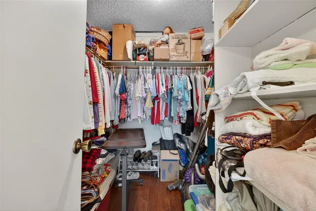 a bathroom with a granite countertop sink a toilet and a mirror