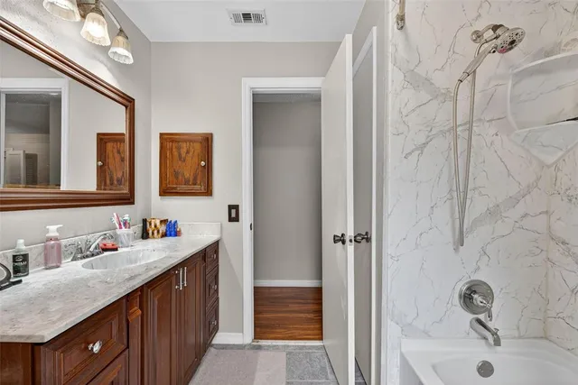 a bedroom with a bed cabinets and window