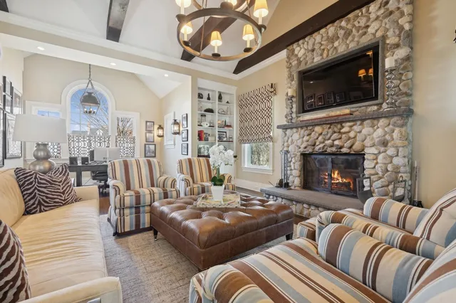 a living room with furniture fireplace and flat screen tv