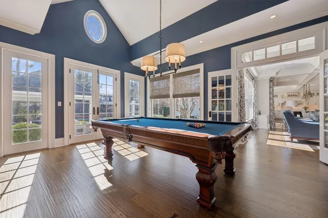 a room with table chairs and wooden floor