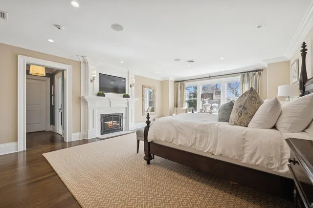 a spacious bedroom with a large bed and a flat screen tv