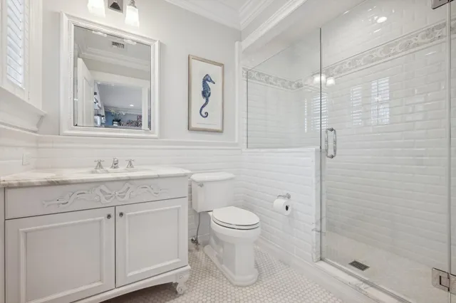 a bathroom with a granite countertop sink a toilet and a mirror