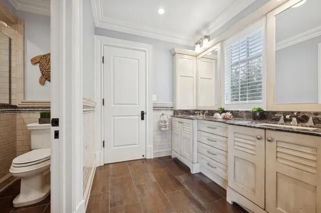 a spacious bedroom with a large bed and a chandelier