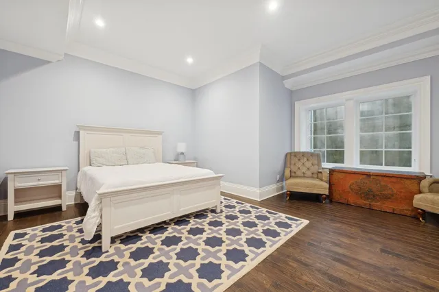 a bathroom with a double vanity sink a toilet and shower