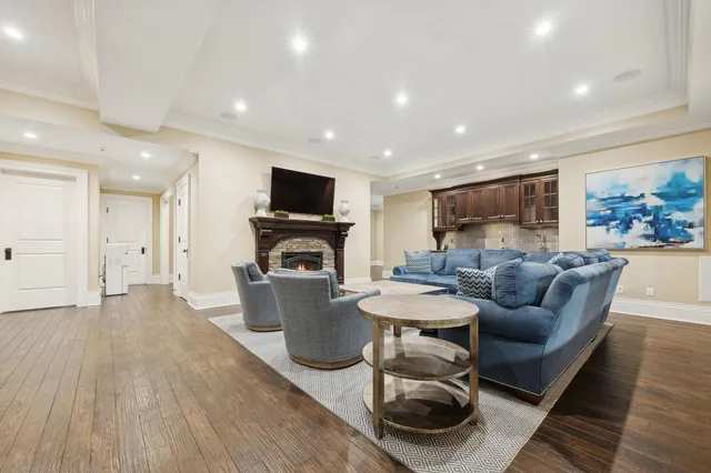 a living room with lots of furniture and a wooden floor