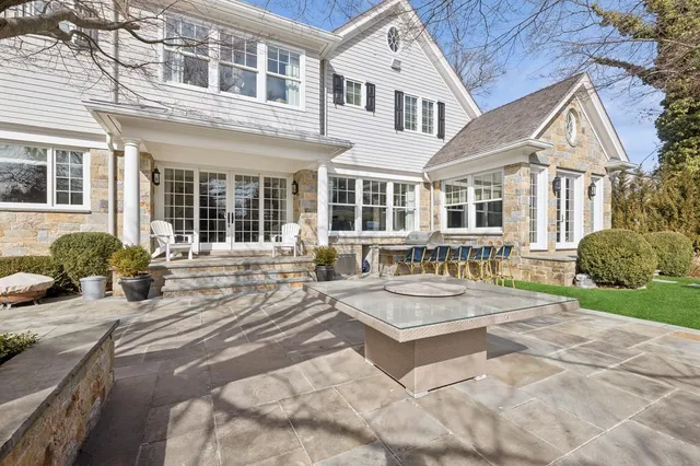 a outdoor living space with furniture garden view and a fireplace