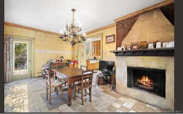a view of a dining room with furniture and a fireplace