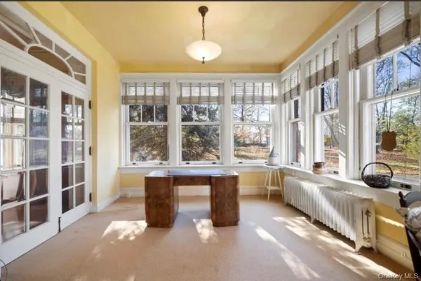 a large kitchen with kitchen island a large window in it