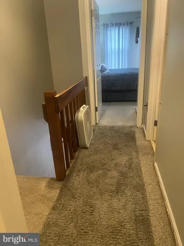 a view of hallway with bathroom