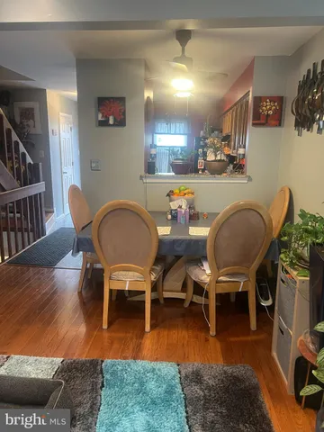 a view of a dining room with furniture wooden floor and a rug