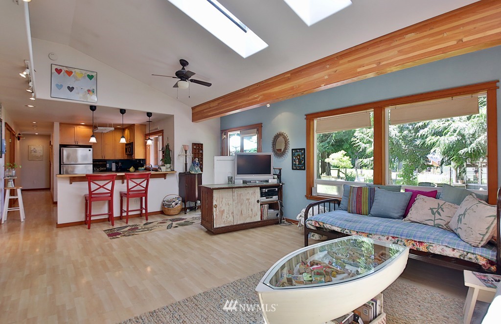 3608 East Harbor Road Langley, WA 98260 - Photo 8 of 25 a living room with furniture a flat screen tv and a large window