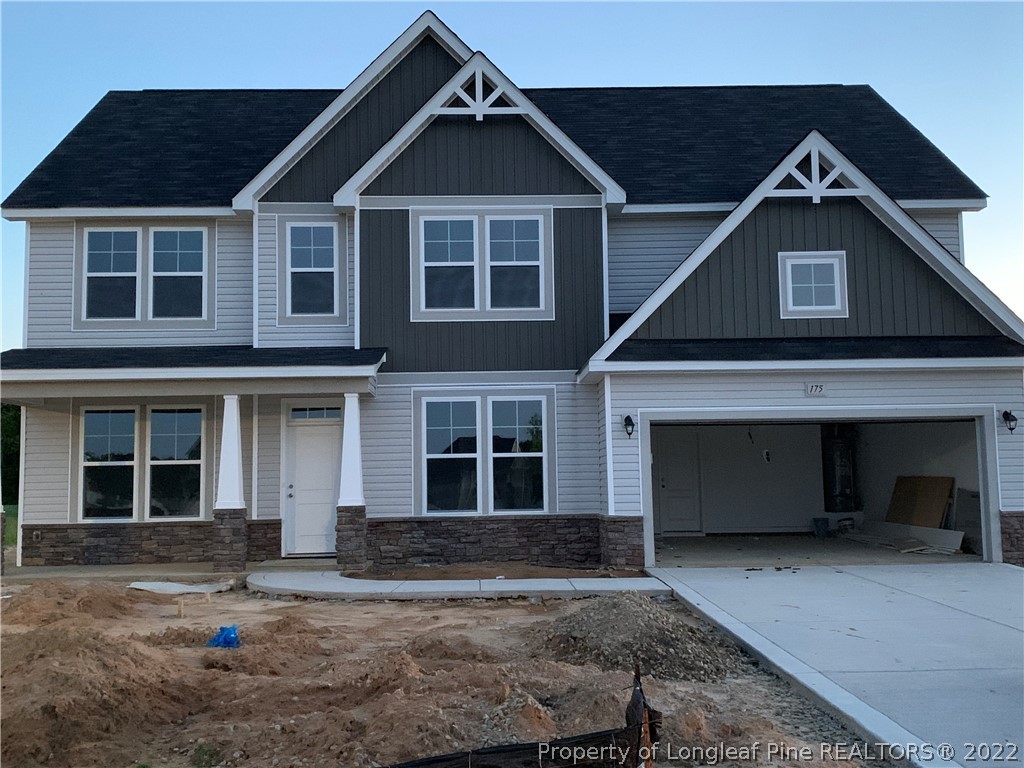 175 Mill Ridge Court Godwin, NC 28344 - Photo 1 of 1 a front view of a house with a yard and garage