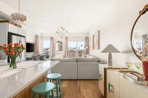 a living room with furniture and a chandelier