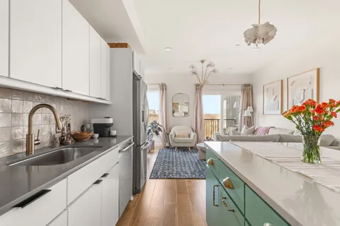 a kitchen with sink and cabinets
