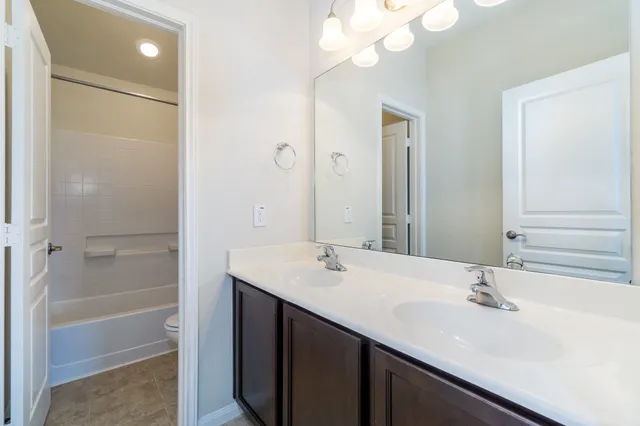a bathroom with a sink a mirror and a shower