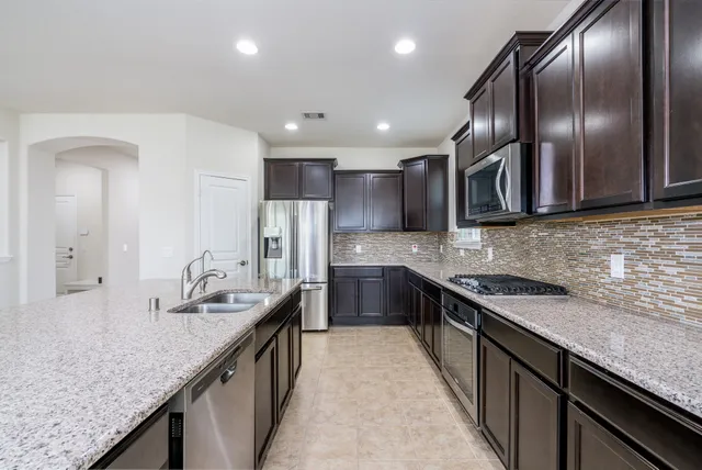 a kitchen with granite countertop stainless steel appliances lots of counter top space