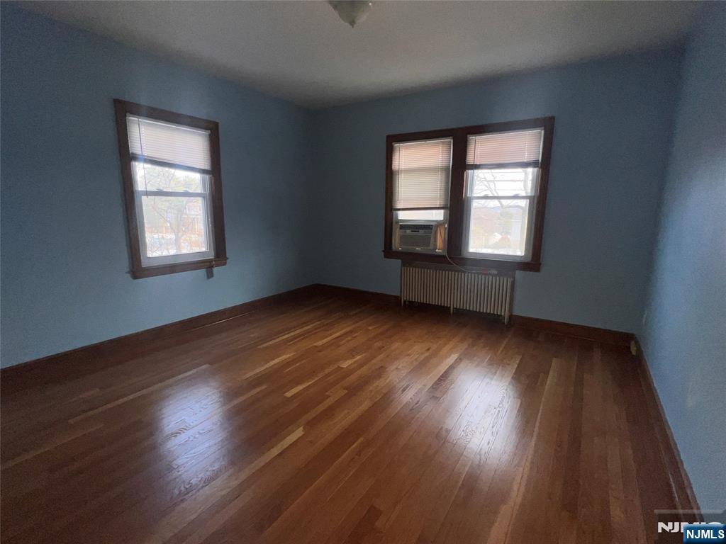 628 Valley Road Clifton, NJ 07013 - Photo 2 of 6 a view of an empty room with wooden floor and a window