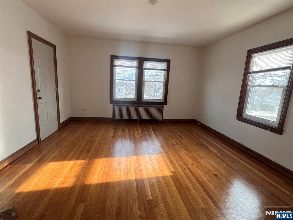 628 Valley Road Clifton, NJ 07013 - Photo 3 of 6 wooden floor in an empty room with a window