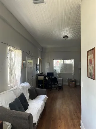 a living room with furniture window and wooden floor