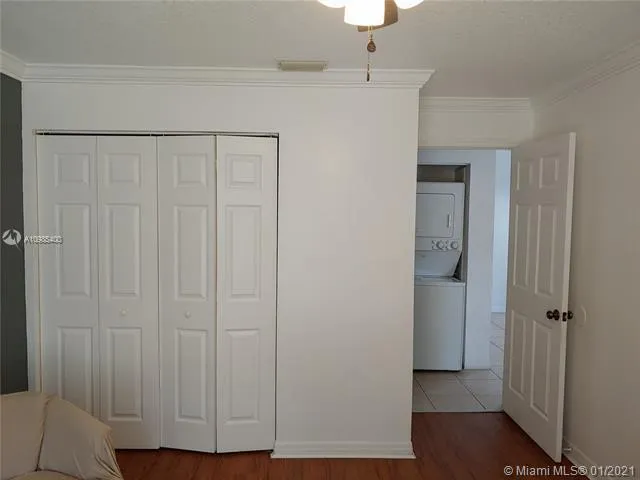 a view of a closet area with hardwood floor