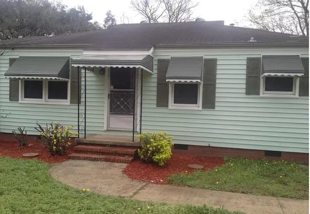 a front view of a house with garden