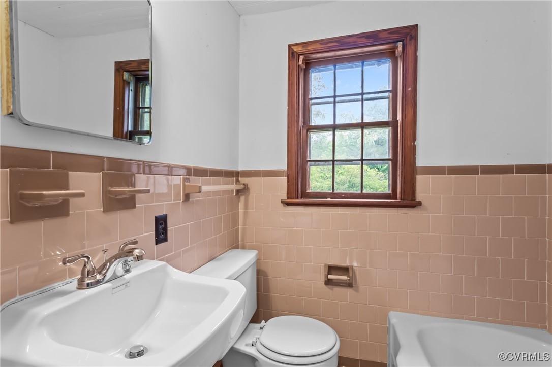 14831 Harrowgate Road Chester, VA 23831 - Photo 17 of 33 a bathroom with a sink a toilet and mirror