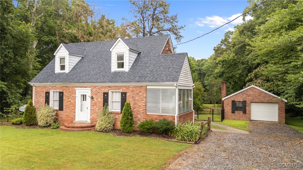 14831 Harrowgate Road Chester, VA 23831 - Photo 23 of 33 a front view of a house with a yard and garage