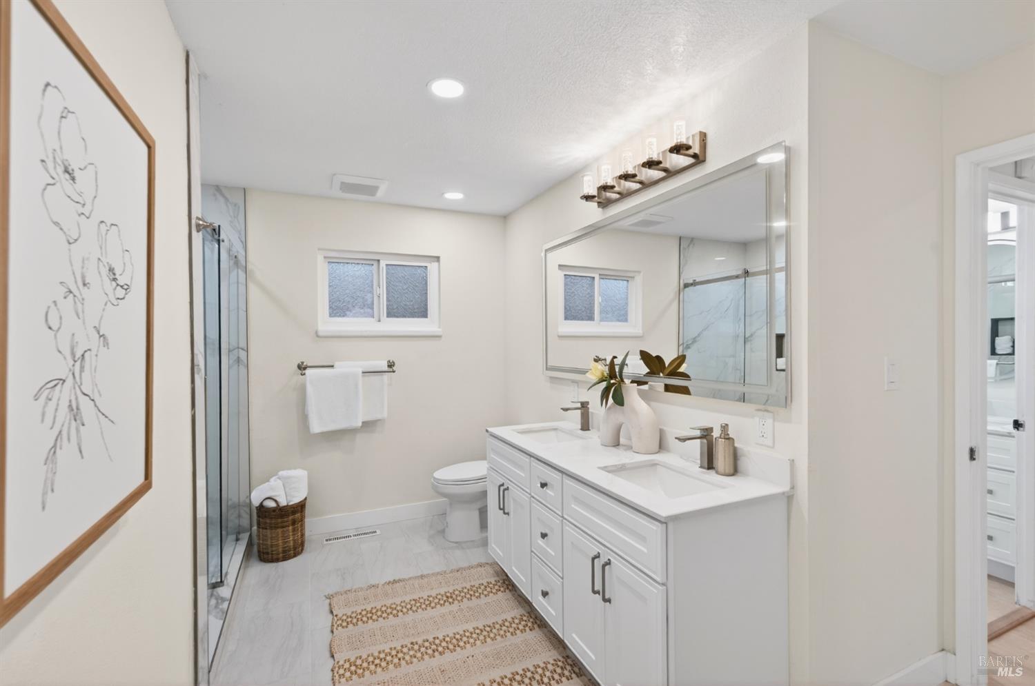 2447 Rigdon Street Napa, CA 94558 - Photo 42 of 79 a bathroom with double vanity sink and a mirror