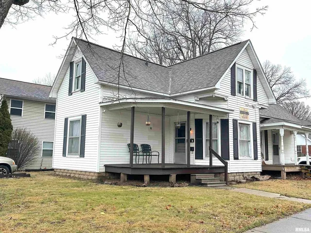 a view of a house with a yard balcony and sitting area