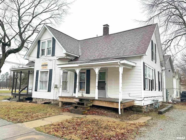 a view of a house with a yard and wooden fence