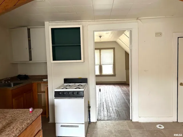 a kitchen with a refrigerator and a stove