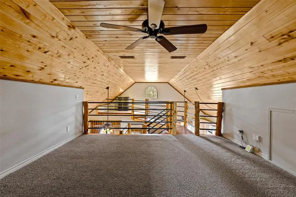 a roof deck with table and chairs and wooden floor