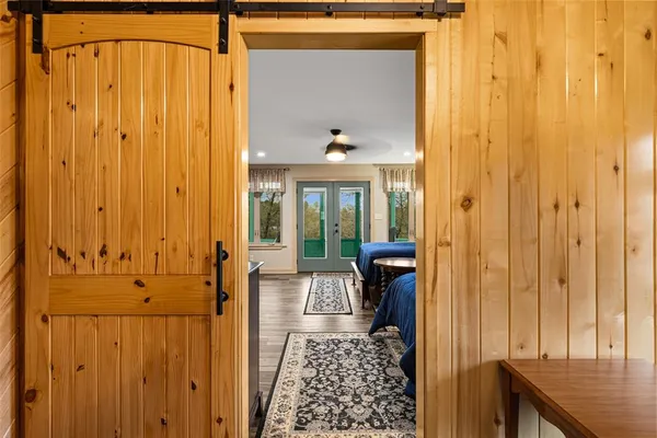 a living room with furniture a flat screen tv and a floor to ceiling window