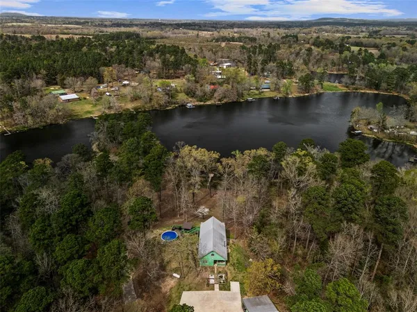 an ocean view with boat and trees