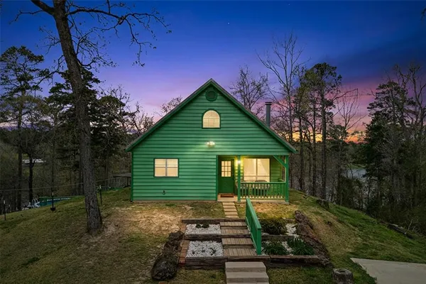 a front view of a house with a yard garage and outdoor seating