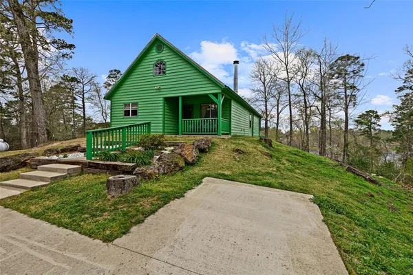 a view of deck with furniture and trees around